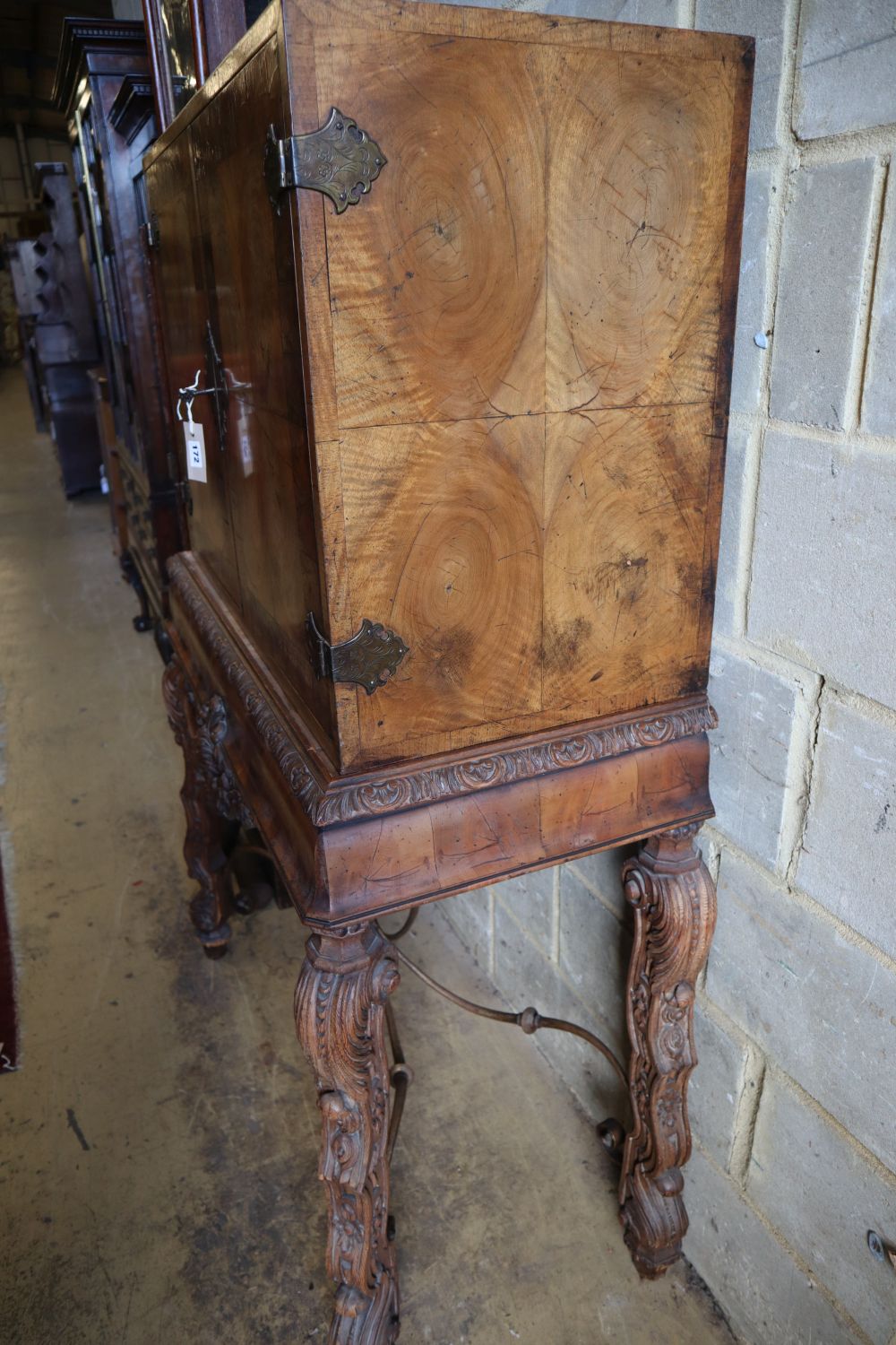 An Italian style walnut oyster veneered cabinet on stand, width 96cm depth 50cm height 147cm